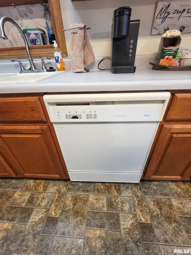 214 W 12th St, Flora, IL 62839 - kitchen view of dishwasher, brown cabinetry, and light countertops