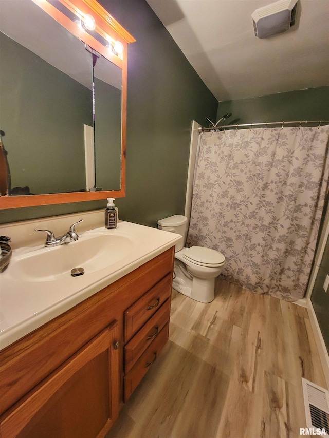 214 W 12th St, Flora, IL 62839 - full bathroom featuring wood finished floors, vanity, toilet, and curtained shower