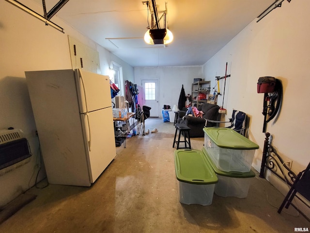 214 W 12th St, Flora, IL 62839 - garage with freestanding refrigerator, a garage door opener, and heating unit