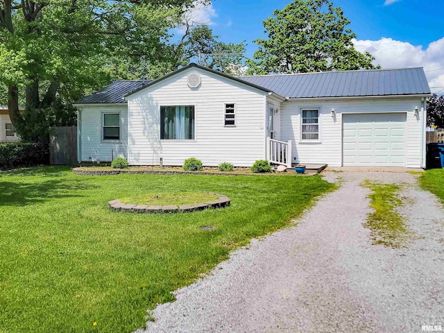 214 W 12th St, Flora, IL 62839 - ranch-style home featuring an attached garage, driveway, metal roof, and a front yard
