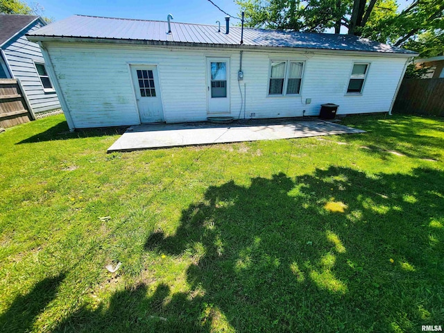 214 W 12th St, Flora, IL 62839 - rear view of property featuring a patio area and metal roof