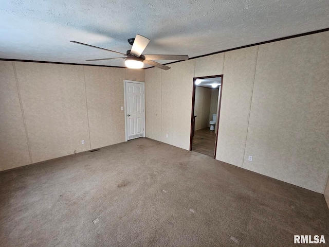 901 W 4th St, Bluford, IL 62814 - unfurnished bedroom with ornamental molding, a textured ceiling, carpet flooring, a decorative wall, and a ceiling fan