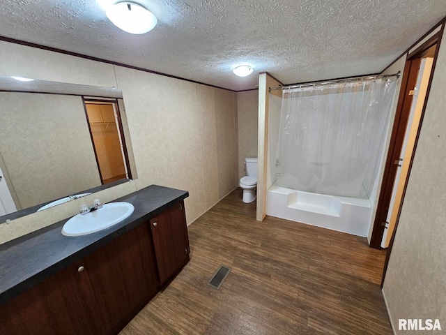 901 W 4th St, Bluford, IL 62814 - bathroom with wood finished floors, toilet, a textured ceiling, vanity, and shower / tub combo