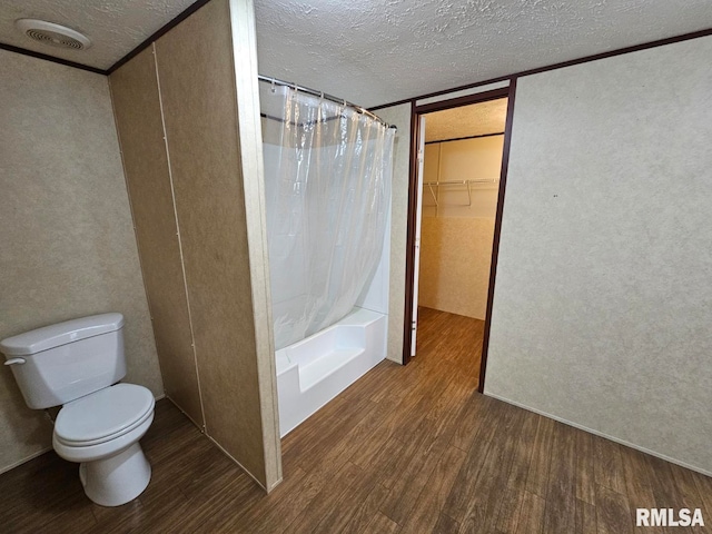901 W 4th St, Bluford, IL 62814 - bathroom with wood finished floors, a textured ceiling, toilet, and a textured wall