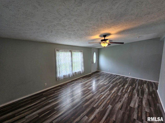 901 W 4th St, Bluford, IL 62814 - empty room with dark wood-style floors, baseboards, a ceiling fan, and a textured ceiling