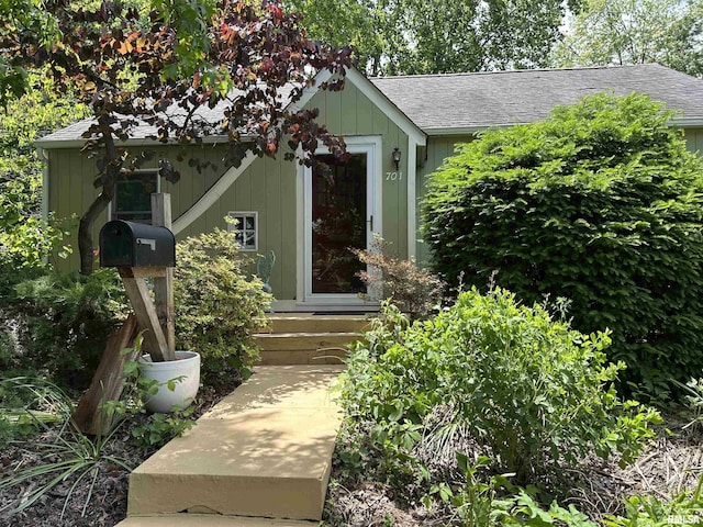 property entrance with a shingled roof