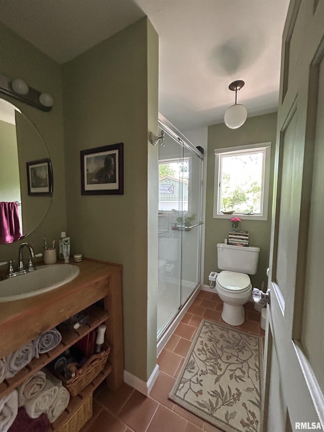 bathroom featuring toilet, a stall shower, tile patterned flooring, vanity, and baseboards