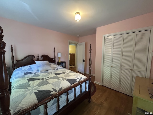 bedroom with wood finished floors, a closet, and baseboards