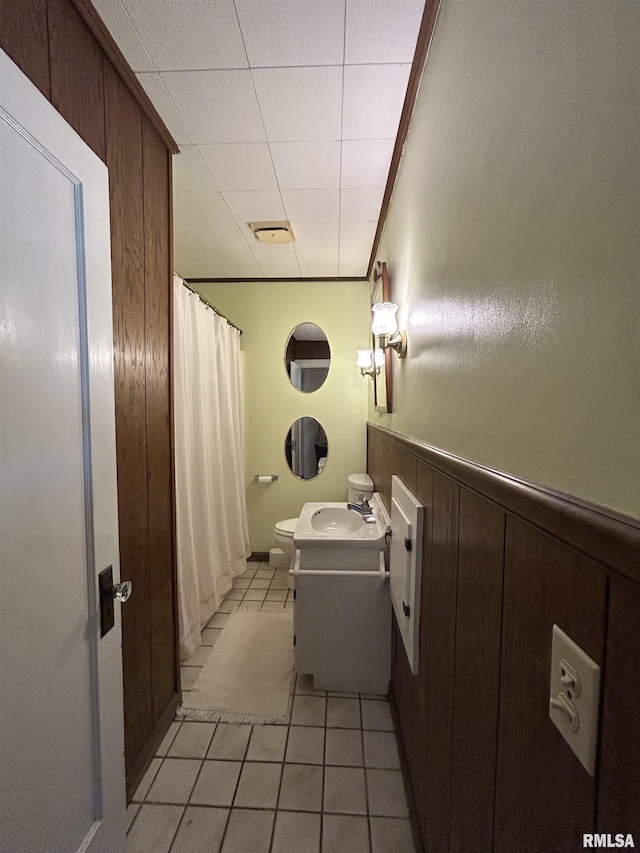 full bath with tile patterned floors, toilet, a wainscoted wall, vanity, and a shower with curtain