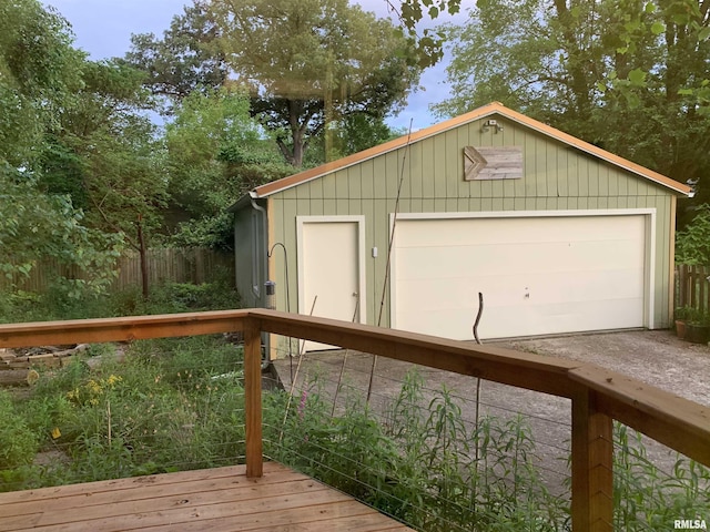 detached garage featuring fence