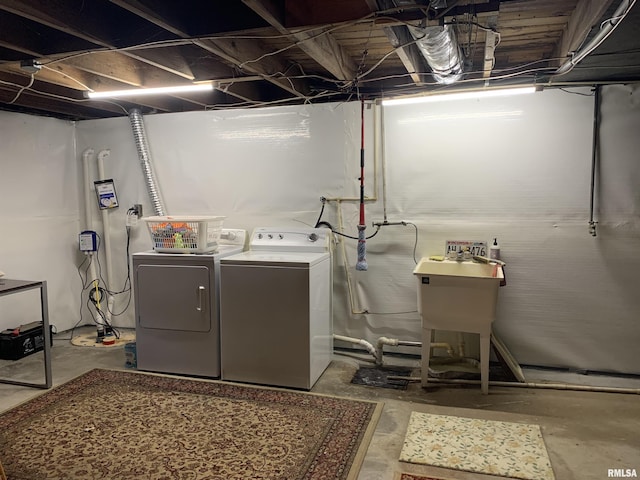 clothes washing area with washing machine and clothes dryer