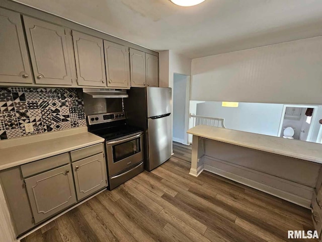 2 Parker Dr, Mount Vernon, IL 62864 - kitchen featuring stainless steel appliances, under cabinet range hood, gray cabinets, decorative backsplash, and dark wood finished floors