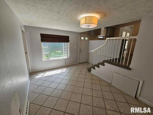 2 Parker Dr, Mount Vernon, IL 62864 - entryway with stairway, light tile patterned floors, a textured ceiling, a textured wall, and baseboards