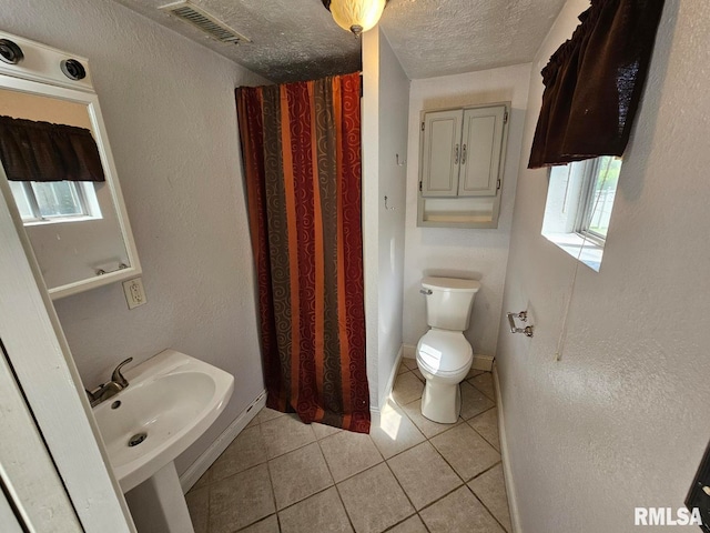 2 Parker Dr, Mount Vernon, IL 62864 - bathroom featuring tile patterned floors, a textured ceiling, toilet, and a sink