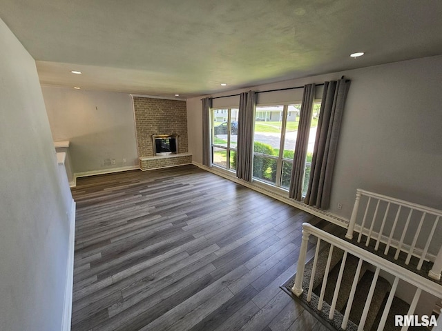 2 Parker Dr, Mount Vernon, IL 62864 - unfurnished living room with dark wood-type flooring, recessed lighting, a brick fireplace, and baseboards