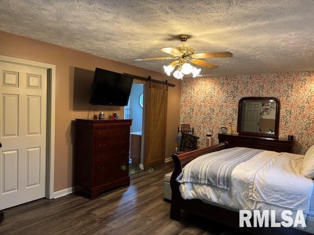 1500 Saint Andrews Pl, Herrin, IL 62948 - bedroom with a barn door, baseboards, a textured ceiling, wood finished floors, and a ceiling fan