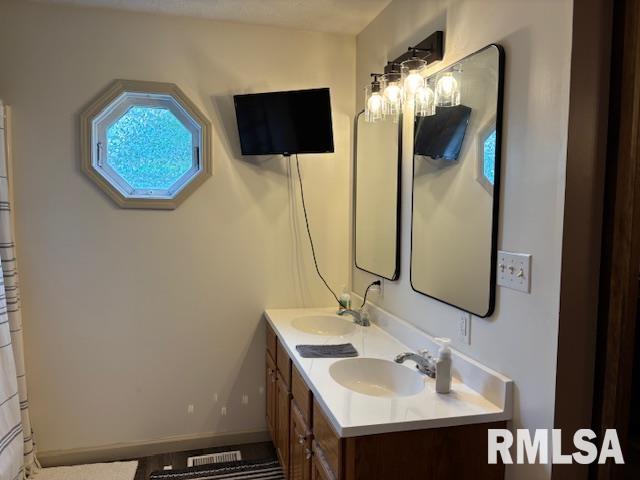 1500 Saint Andrews Pl, Herrin, IL 62948 - full bathroom with double vanity and baseboards