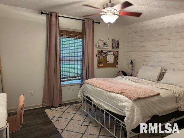 1500 Saint Andrews Pl, Herrin, IL 62948 - bedroom featuring wood finished floors, a ceiling fan, and wooden walls