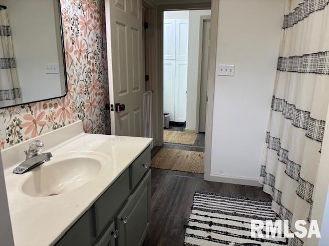 1500 Saint Andrews Pl, Herrin, IL 62948 - full bath with wood finished floors, vanity, wallpapered walls, and baseboards