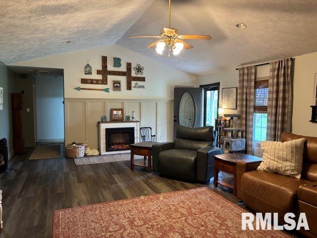 1500 Saint Andrews Pl, Herrin, IL 62948 - living area featuring ceiling fan, a fireplace, lofted ceiling, a textured ceiling, and dark wood finished floors