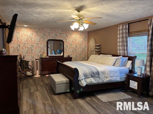1500 Saint Andrews Pl, Herrin, IL 62948 - bedroom with a textured ceiling, wood finished floors, wallpapered walls, and ceiling fan