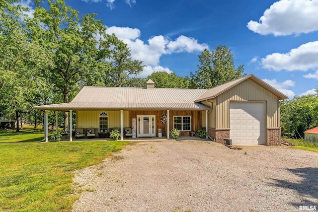 540 Kendall Ln, Marion, IL 62959 - view of front of home with dirt driveway, an attached garage, a front yard, a chimney, and metal roof