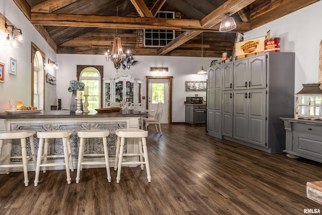 540 Kendall Ln, Marion, IL 62959 - kitchen with dark wood finished floors, gray cabinetry, a kitchen bar, a peninsula, and wood ceiling with exposed beams