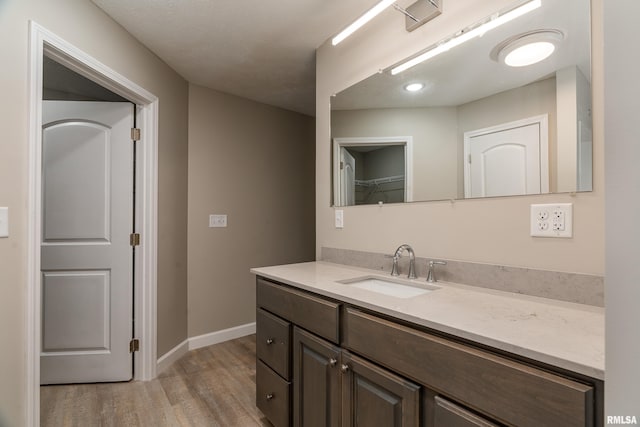 308 Prentice Ave, Carterville, IL 62918 - bathroom with wood finished floors, vanity, and baseboards