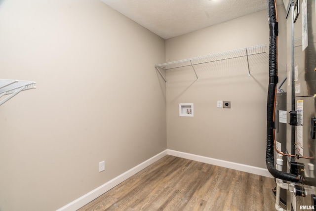 308 Prentice Ave, Carterville, IL 62918 - laundry area featuring hookup for an electric dryer, wood finished floors, baseboards, and hookup for a washing machine