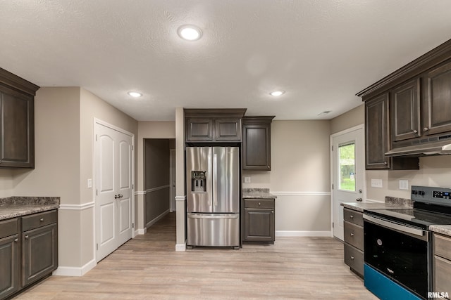 308 Prentice Ave, Carterville, IL 62918 - kitchen with stainless steel appliances, dark brown cabinetry, under cabinet range hood, light wood finished floors, and baseboards