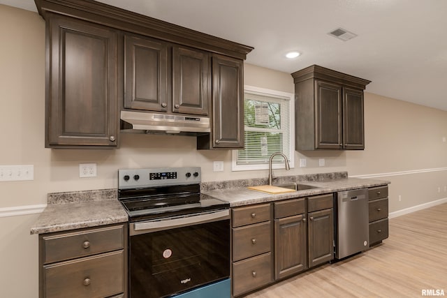 308 Prentice Ave, Carterville, IL 62918 - kitchen with stainless steel appliances, under cabinet range hood, a sink, light wood finished floors, and dark brown cabinetry