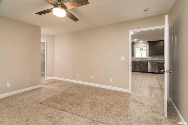 308 Prentice Ave, Carterville, IL 62918 - empty room with a sink, light carpet, a ceiling fan, and baseboards