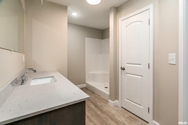308 Prentice Ave, Carterville, IL 62918 - full bath featuring wood finished floors, a stall shower, vanity, and baseboards