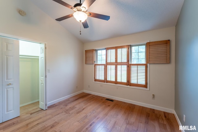 1021 Meadowlark Dr, Carterville, IL 62918 - unfurnished bedroom featuring light wood-style flooring, baseboards, lofted ceiling, a ceiling fan, and a closet
