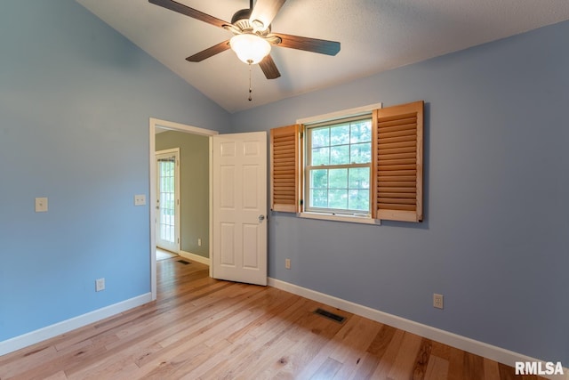 1021 Meadowlark Dr, Carterville, IL 62918 - unfurnished room with a ceiling fan, light wood-style flooring, baseboards, and vaulted ceiling