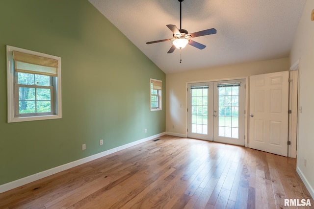 1021 Meadowlark Dr, Carterville, IL 62918 - spare room featuring french doors, plenty of natural light, ceiling fan, baseboards, and high vaulted ceiling