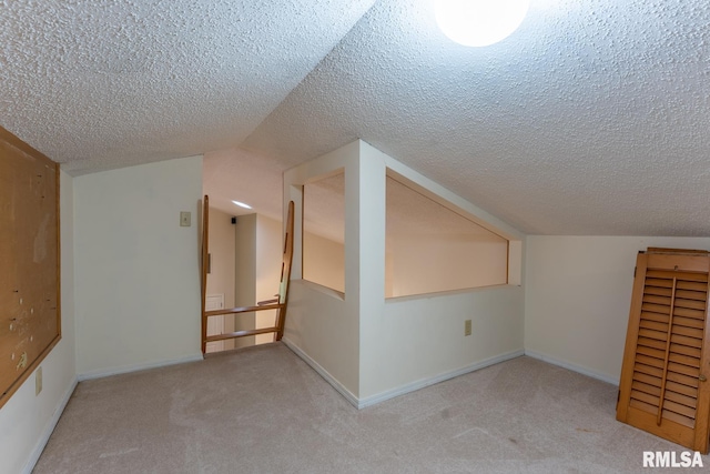 1021 Meadowlark Dr, Carterville, IL 62918 - additional living space featuring carpet floors, a textured ceiling, baseboards, and vaulted ceiling