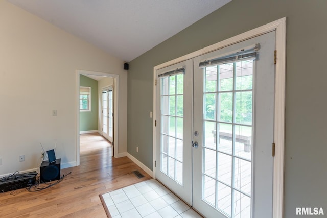 1021 Meadowlark Dr, Carterville, IL 62918 - entryway featuring french doors, lofted ceiling, light wood-style floors, and baseboards
