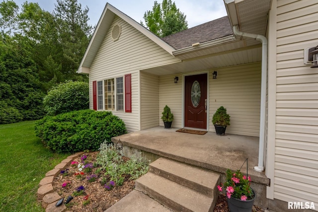 1021 Meadowlark Dr, Carterville, IL 62918 - view of exterior entry with a shingled roof and a lawn