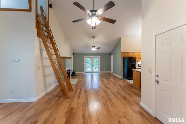 1021 Meadowlark Dr, Carterville, IL 62918 - unfurnished living room with a ceiling fan, light wood finished floors, high vaulted ceiling, and baseboards