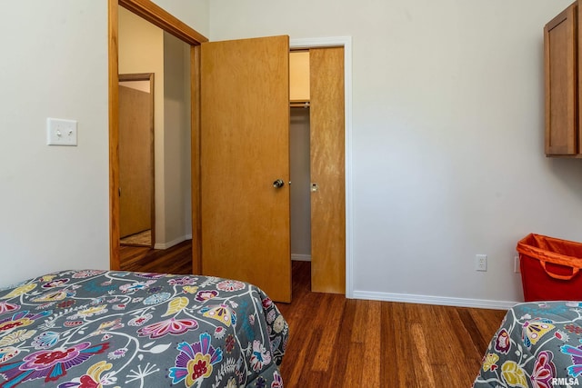 bedroom featuring wood finished floors and baseboards