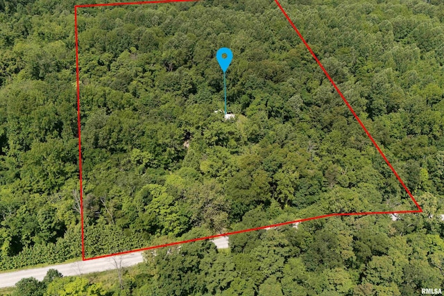aerial overview of property's location featuring a heavily wooded area and property parcel outlined