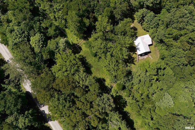 aerial overview of property's location featuring a heavily wooded area