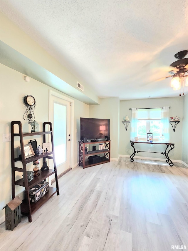 1144 S Morningside Dr, Carbondale, IL 62901 - living area with wood finished floors, ceiling fan, baseboards, and a textured ceiling