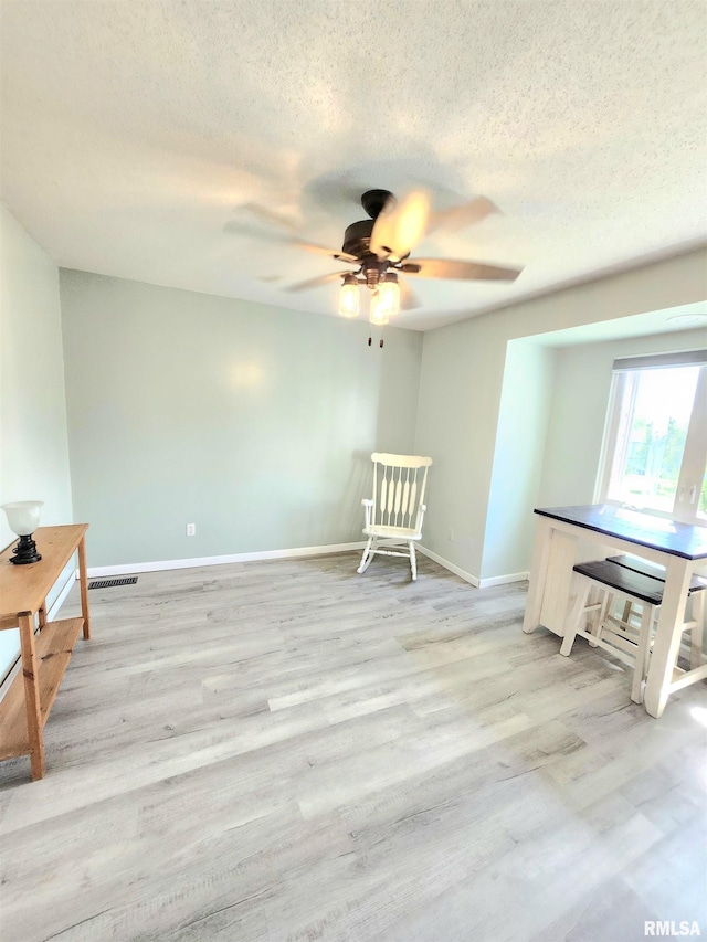 1144 S Morningside Dr, Carbondale, IL 62901 - unfurnished room with a textured ceiling, ceiling fan, light wood-type flooring, and baseboards