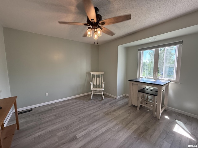 1144 S Morningside Dr, Carbondale, IL 62901 - sitting room featuring wood finished floors, a textured ceiling, a ceiling fan, and baseboards