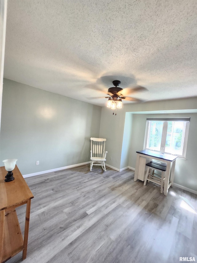 1144 S Morningside Dr, Carbondale, IL 62901 - living area with a textured ceiling, a ceiling fan, wood finished floors, and baseboards