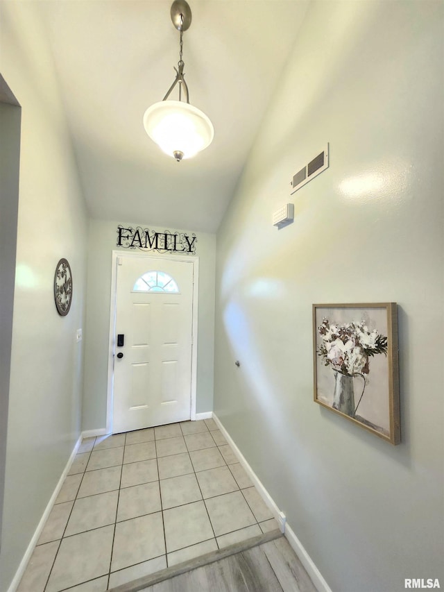 1144 S Morningside Dr, Carbondale, IL 62901 - doorway to outside with baseboards, light tile patterned floors, and vaulted ceiling
