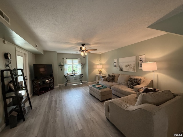 1144 S Morningside Dr, Carbondale, IL 62901 - living room featuring a textured ceiling, ceiling fan, light wood finished floors, and baseboards