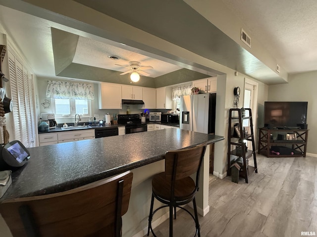 1144 S Morningside Dr, Carbondale, IL 62901 - kitchen with black appliances, dark countertops, white cabinetry, a sink, and baseboards